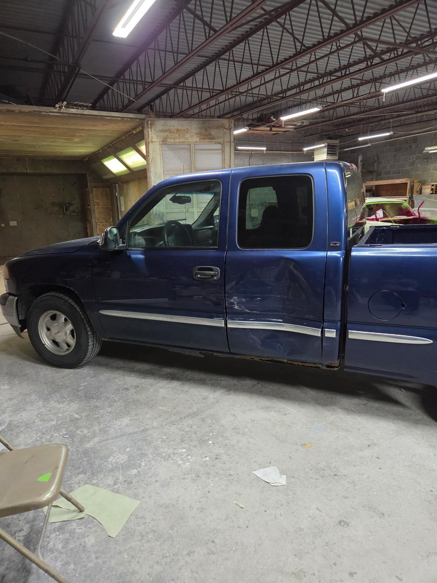 Blue GMC truck replacement doors before paint matching and blend